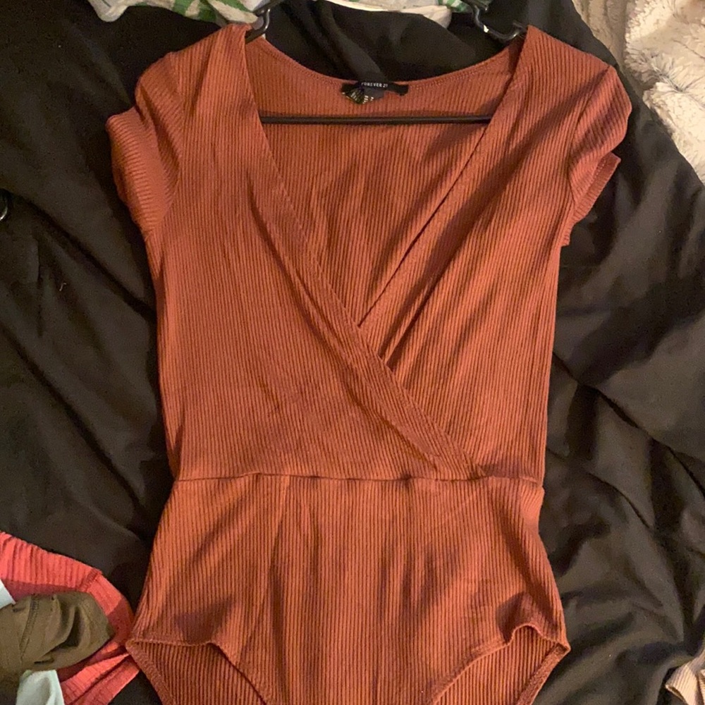Forever 21 bodysuit , I’m not sure of the color but it’s like a brown burgandy